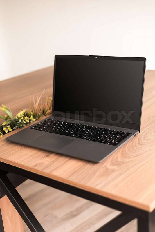 Stylish desk setup with a modern laptop as the focal point, evoking productivity, simplicity