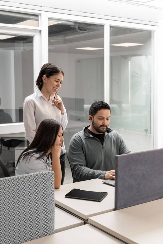 coworkers listening as their manager explains how to approach a new client project