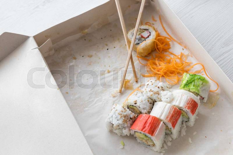 packaging in a cardboard box, with few sushi rolls, food delivery