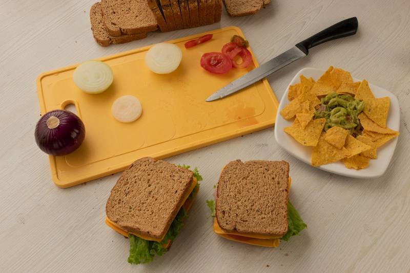 food preparation on a table chopping board with fresh vegetables cut by knife