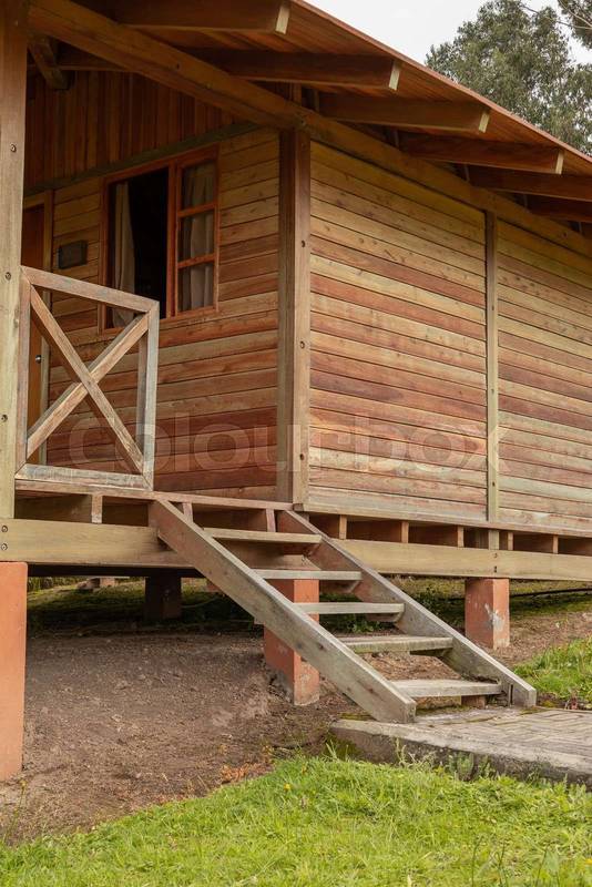 wooden cabin with balcony and stairs