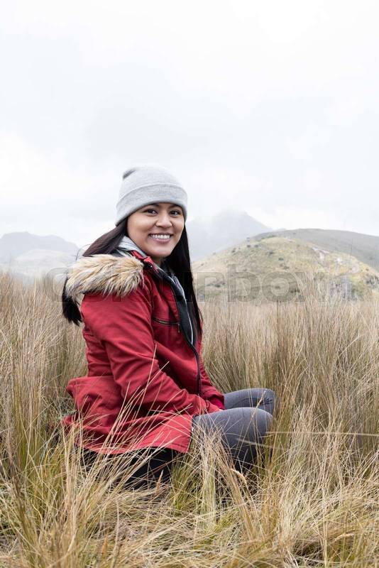 young latin woman wearing a wool cap, jacket for the cold, winter clothes in the countryside