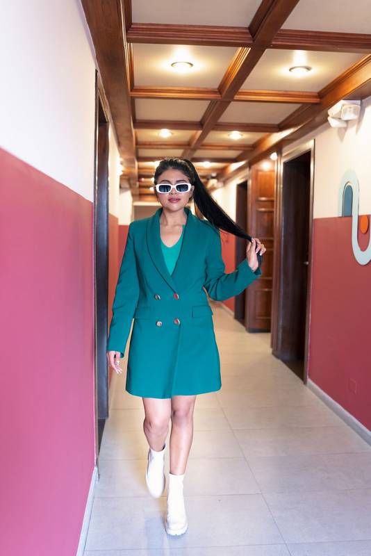 glamorous walking young woman with ponytail wearing jacket style