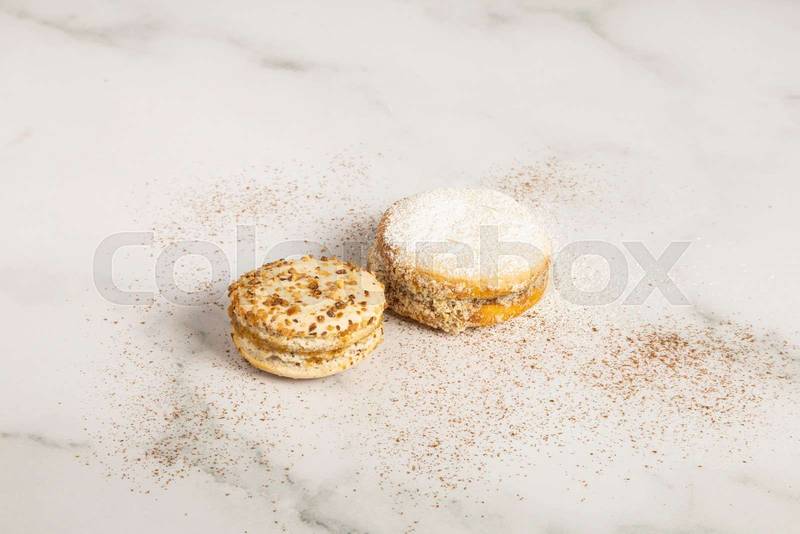 alfajores decorated with sugar on a textured table, detail of sweet food