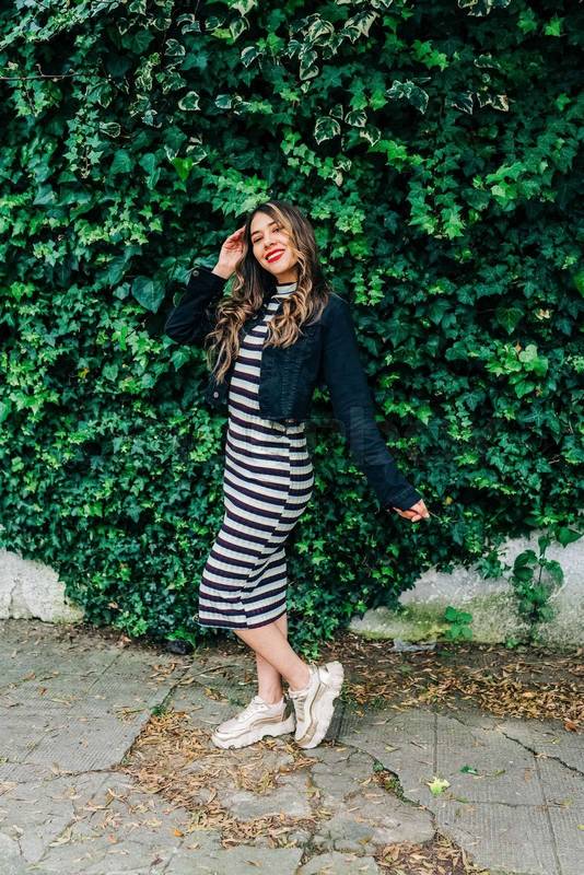 outdoor full body shot of slim, young latin woman