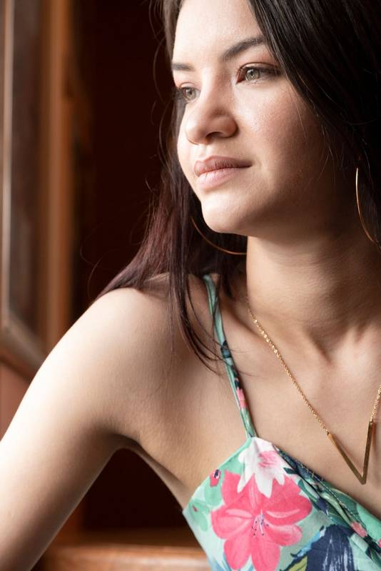 smiling showing neck, wearing necklace and earrings, beauty and style
