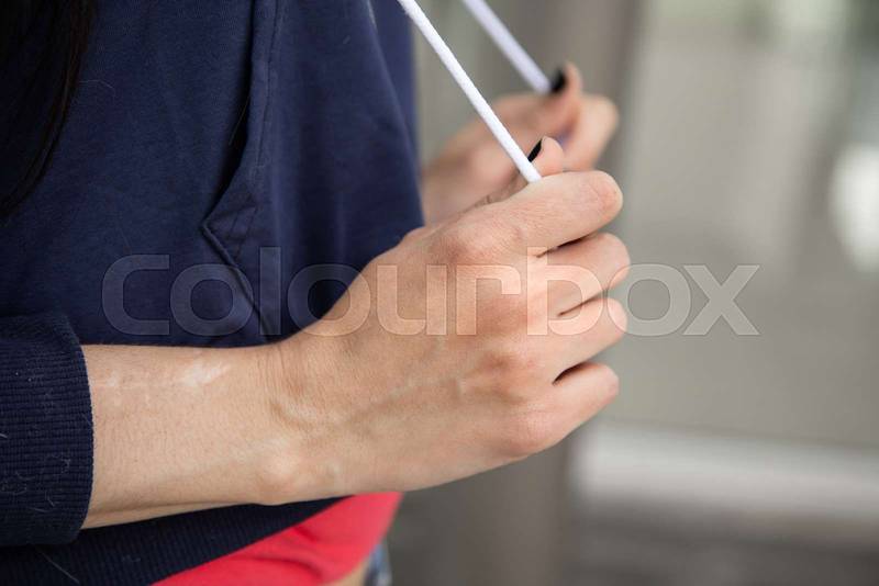 hand of a person holding the cord of his sports sweater
