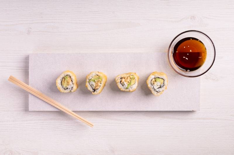 restaurant,sushi rolls next to a bowl, menu