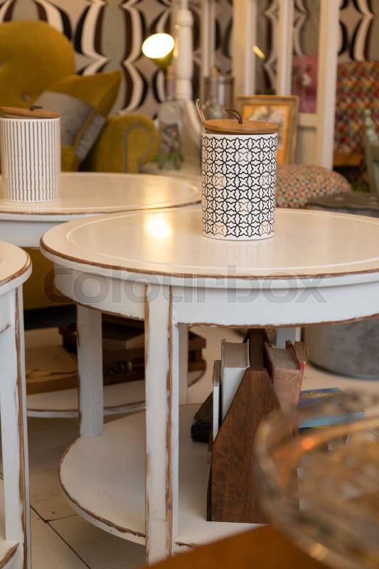 decoration of a living room with some worn and old white wooden tables with decorative objects, furniture