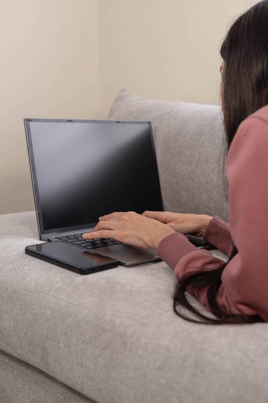 # laptop screen, relaxing in a casual, cozy environment, enjoying a peaceful and calm moment.