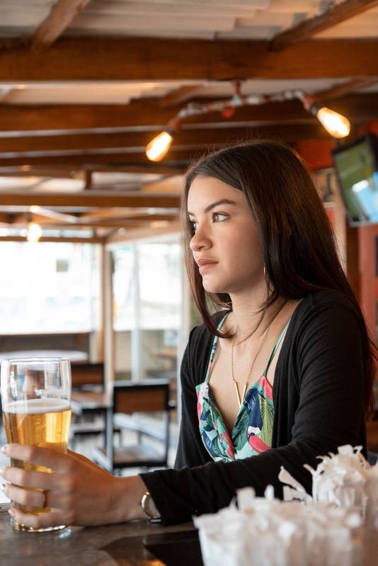 decor with  wooden furniture, while holding a drink in a crystal glass