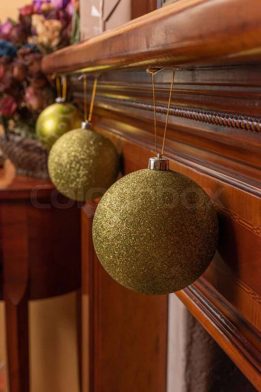 interior decoration, arranged in a row three frosted green spheres hanging on a wooden base