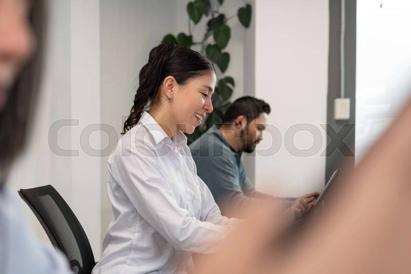 man and woman smile as they exchange ideas and work