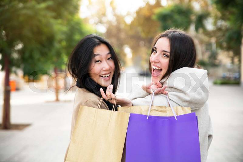 Happy young women shopping in the city