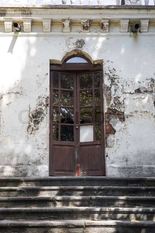 old wooden door with glass panes on a colonial Ecuadorian hacienda