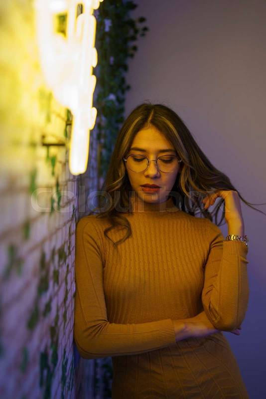 young woman with long hair and glasses as accessory, red lips makeup, modern model and portrait