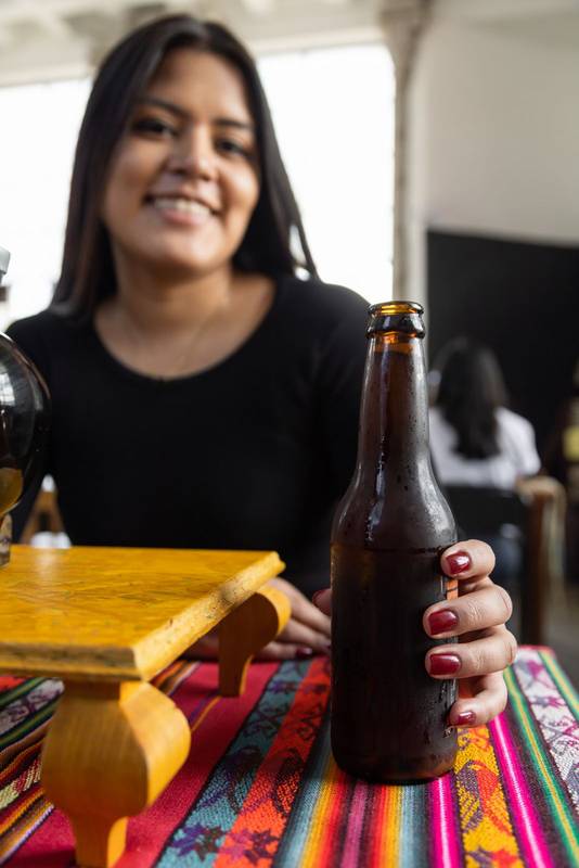 drinking a beer young latin woman, break time