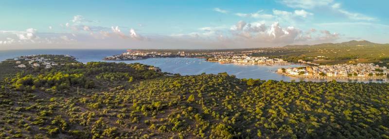 panoramic aerial view at sunrise, fishing port, typical area of tourist interest, holiday destinations and hotel zone.Portocolom, Majorca, Balearic Islands
