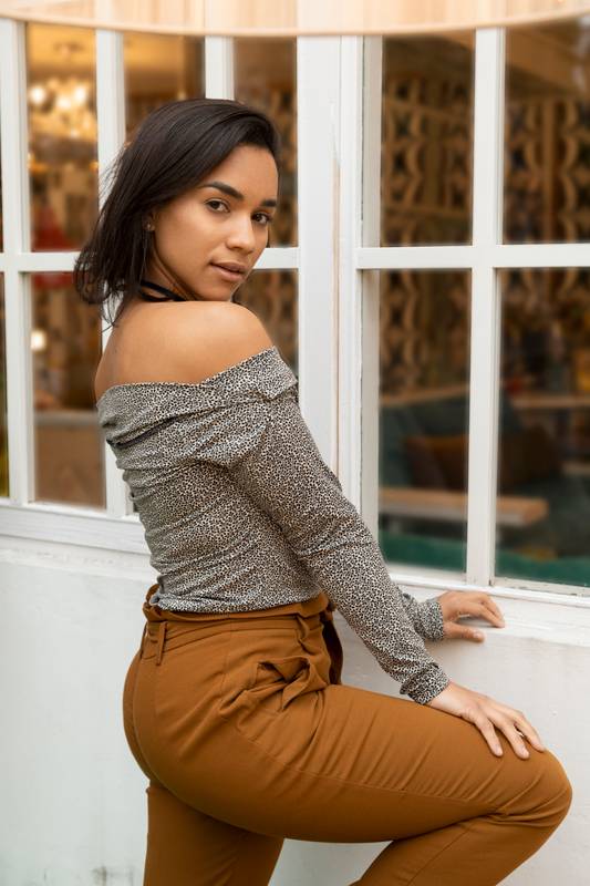 smiling standing while posing, wearing glamorous casual clothes