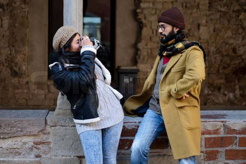 cheerful woman taking a picture to his boyfriend - holidays concept