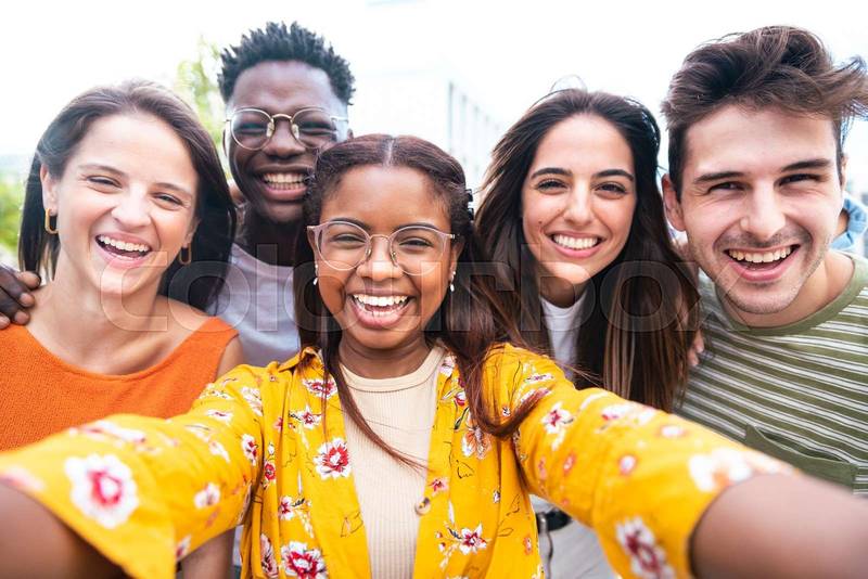 Multicultural friends taking selfie picture outside on city street