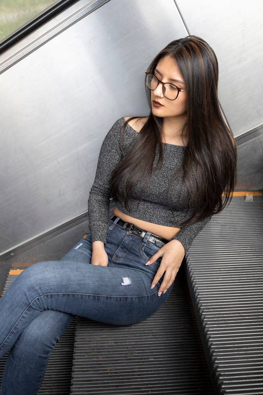 model  is resting sitting on some stairs