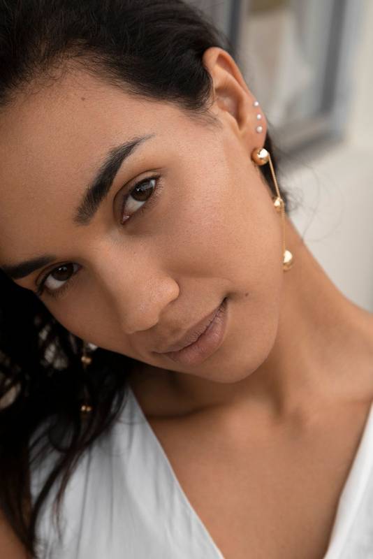 woman with short hair, detail of her natural beauty, jewerly
