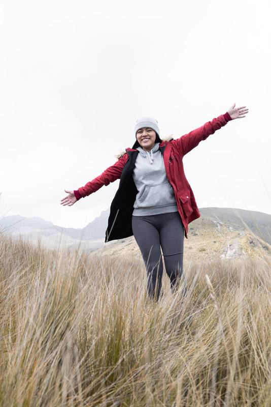 enjoying nature a latin young woman wear a wool cap, jacket for the cold, winter fashion