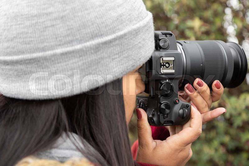 photographer lifestyle in the field working, young woman