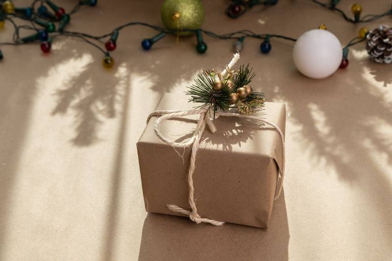 gift in the form of a box with a bow and christmas decoration, beauty in sharing