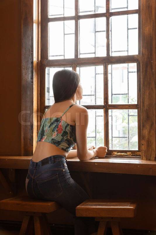 Slim young woman with long hair wearing casual clothes, restaurant