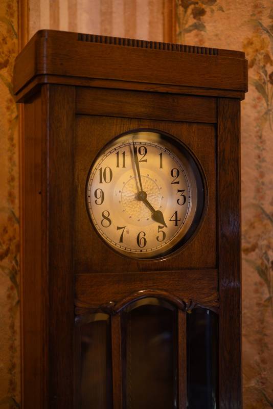 Elegant grandfather clock crafted from dark wood, showing vintage details