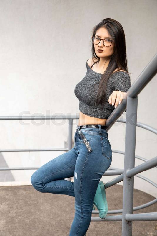 full body shot of a latin woman with long black hair, standing with glasses, casual lifestyle