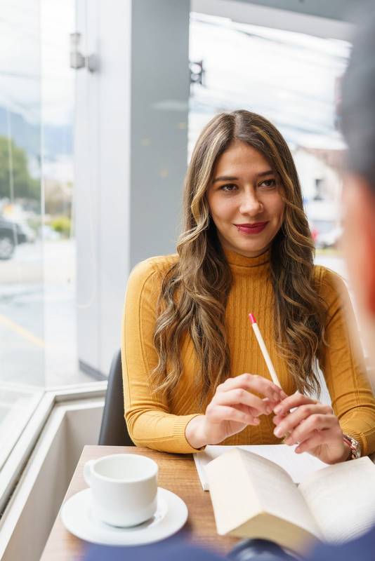 beauty young latin woman with blonde hair smiling, with an open book