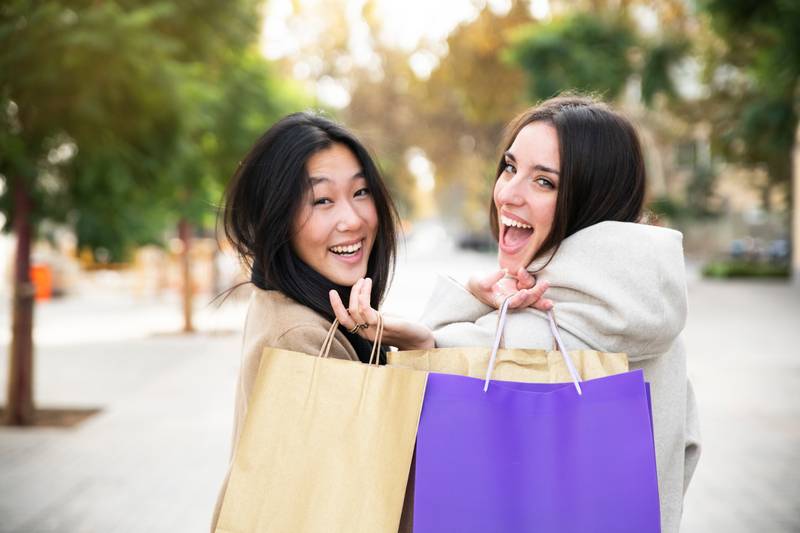 Happy young women shopping in the city