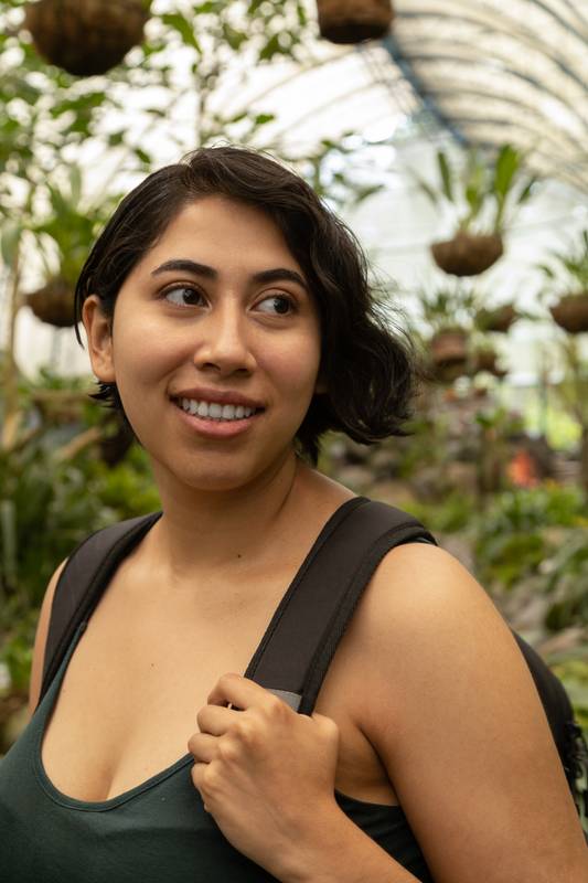 woman with short hair, traveler lifestyle with plants in the background